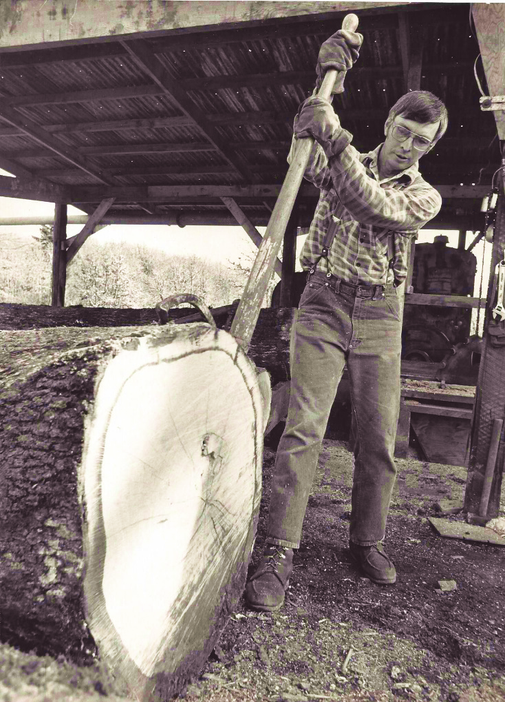 Bill Monroe rolls a large Oak log with a peavey